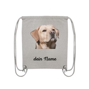 May include: A gray drawstring bag with a picture of a golden retriever dog on the front. The bag has the text "dein Name" printed below the image.