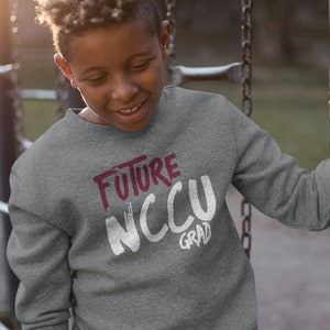 May include: A gray sweatshirt with the text "FUTURE NCCU GRAD" in white and maroon lettering.