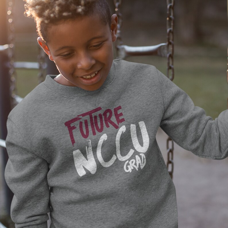 May include: A gray sweatshirt with the text "FUTURE NCCU GRAD" in white and maroon lettering.