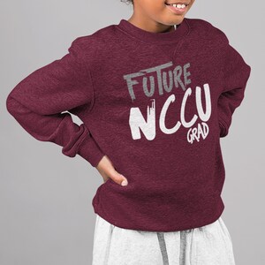 May include: A maroon sweatshirt with the text "FUTURE NCCU GRAD" in white and gray lettering.