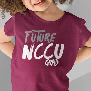 May include: A maroon t-shirt with the text "FUTURE NCCU GRAD" in white and gray lettering.