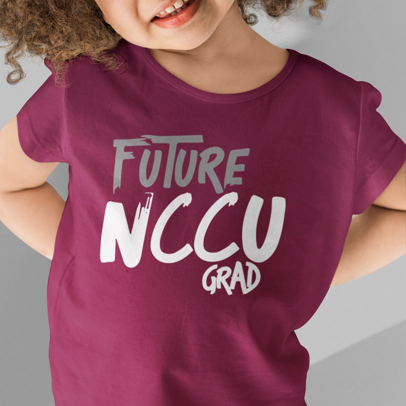 May include: A maroon t-shirt with the text "FUTURE NCCU GRAD" in white and gray lettering.