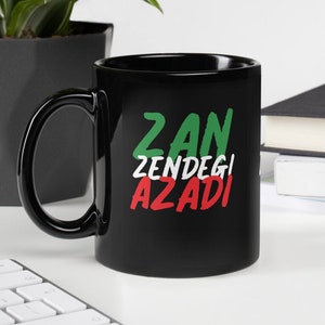 May include: Black ceramic mug with the words "Zan Zendegi Azadi" in green, white, and red lettering.