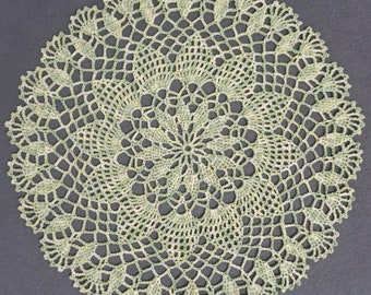 Handmade light green lace crochet doily.