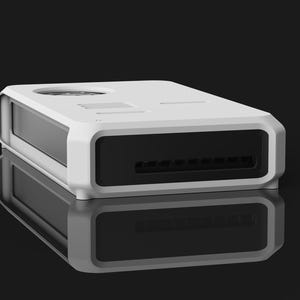 May include: A white rectangular electronic device with a black front panel and a series of vents. The device has a rounded frame and is reflected on a glossy black surface. The top has a circular opening and other small openings.