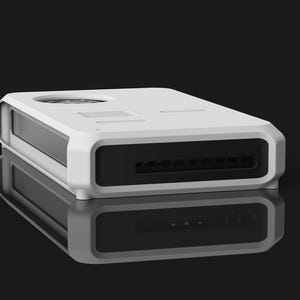 Op de afbeelding: Een wit rechthoekig elektronisch apparaat met een zwart voorpaneel en een cirkelvormige ventilatieopening aan de bovenkant. Het apparaat heeft een strak, modern ontwerp en wordt weerspiegeld op een glanzend zwart oppervlak.