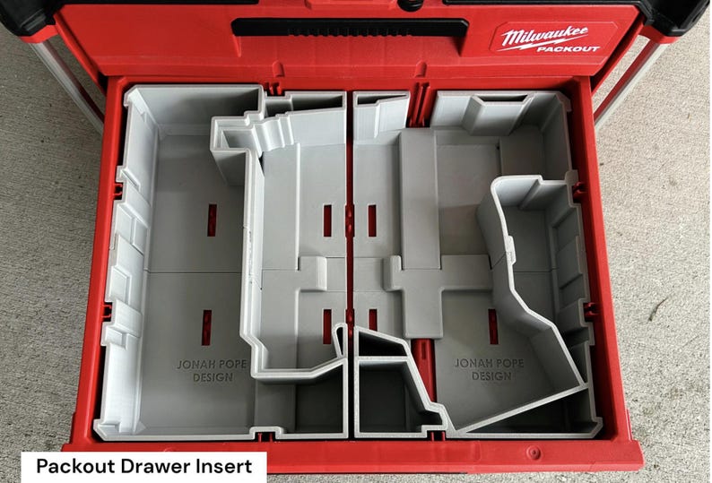 May include: Red Milwaukee Packout drawer with a gray insert. The insert is divided into multiple compartments and features the text "JONAH POPE DESIGN". The Packout drawer is designed for tool organization.