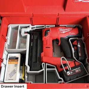 Puede incluir: Una clavadora Milwaukee FUEL roja y un paquete de baterías, organizados dentro de un inserto de cajón Packout rojo. El cajón también contiene grapas y otros accesorios. El texto "Packout Drawer Insert" es visible en la parte inferior.