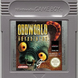 May include: A gray Nintendo Game Boy cartridge featuring the game "Oddworld Adventures." The label displays a green creature with large yellow eyes and the game's title in yellow. The cartridge has text that reads "Made in Japan."