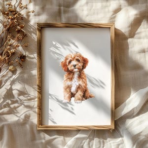 以下が含まれることがあります： 白い背景に茶色と白の犬が描かれた額装されたプリント。犬は座ってカメラを見ている。