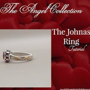 May include: A silver ring with a red gemstone and gold accents. The ring is set against a red background with hearts.
