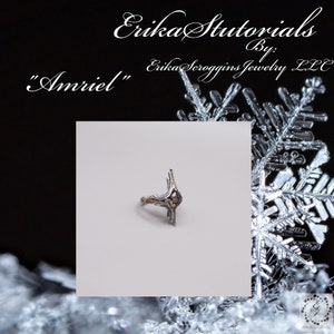 May include: A silver ring with a black stone and intricate details. The ring is set against a white background. "Amriel" is written in cursive above the ring.
