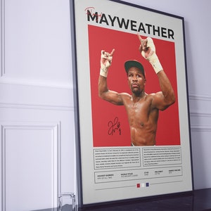 Peut inclure: Une affiche repr&eacute;sentant une image en noir et blanc de Floyd Mayweather Jr. avec les bras lev&eacute;s en signe de victoire. L'affiche a un fond rouge et le texte "Mayweather" en lettres noires. L'affiche comprend &eacute;galement des informations sur la carri&egrave;re de boxeur de Mayweather, notamment ses gains les plus &eacute;lev&eacute;s, ses titres mondiaux, ses d&eacute;buts professionnels et son bilan parfait.