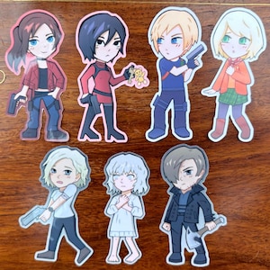 May include: A set of seven die-cut vinyl stickers featuring chibi-style anime characters. The figures include individuals with various hair colors and outfits, some holding small handguns or an axe, and one holding a small teddy bear, all with distinct facial expressions and poses.