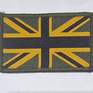 May include: A green fabric patch with a yellow and black Union Jack flag design.