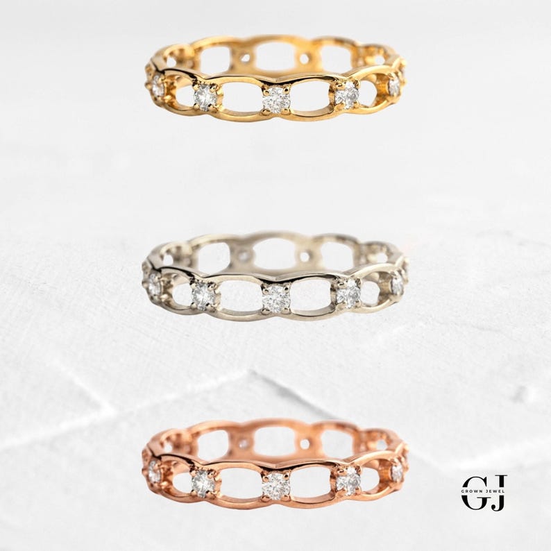 May include: Three delicate rings with a chain-link design and small diamonds set in each link. The rings are shown in gold, silver, and rose gold.