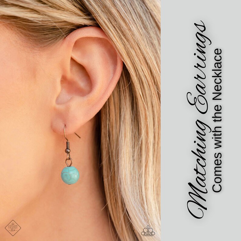 May include: A close-up of a woman's ear wearing a pair of earrings with a turquoise stone and copper accents. The text "Matching Earrings Comes with the Necklace" is visible in the background.