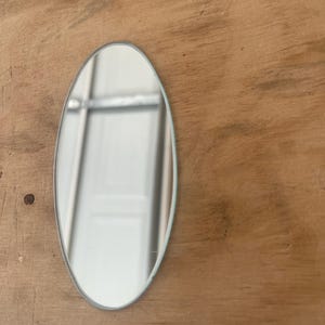 Small custom cut oval shape mirror:  1/8" thickness