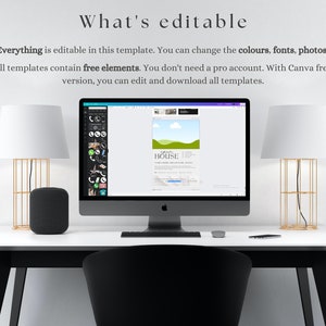May include: A white desktop computer with a black screen displaying a Canva design template for a house. The template has a green lawn, a blue sky with white clouds, and the word "HOUSE" in black text. The computer is on a white desk with a black chair, a black speaker, and two gold lamps.