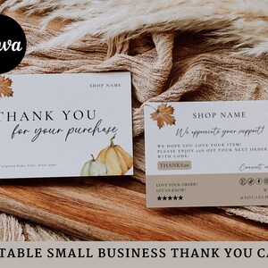 May include: A white thank you card with a fall theme. The card features a watercolor illustration of pumpkins and leaves. The text on the card reads "Thank you for your purchase" and "Shop Name". The back of the card has a discount code and social media information.