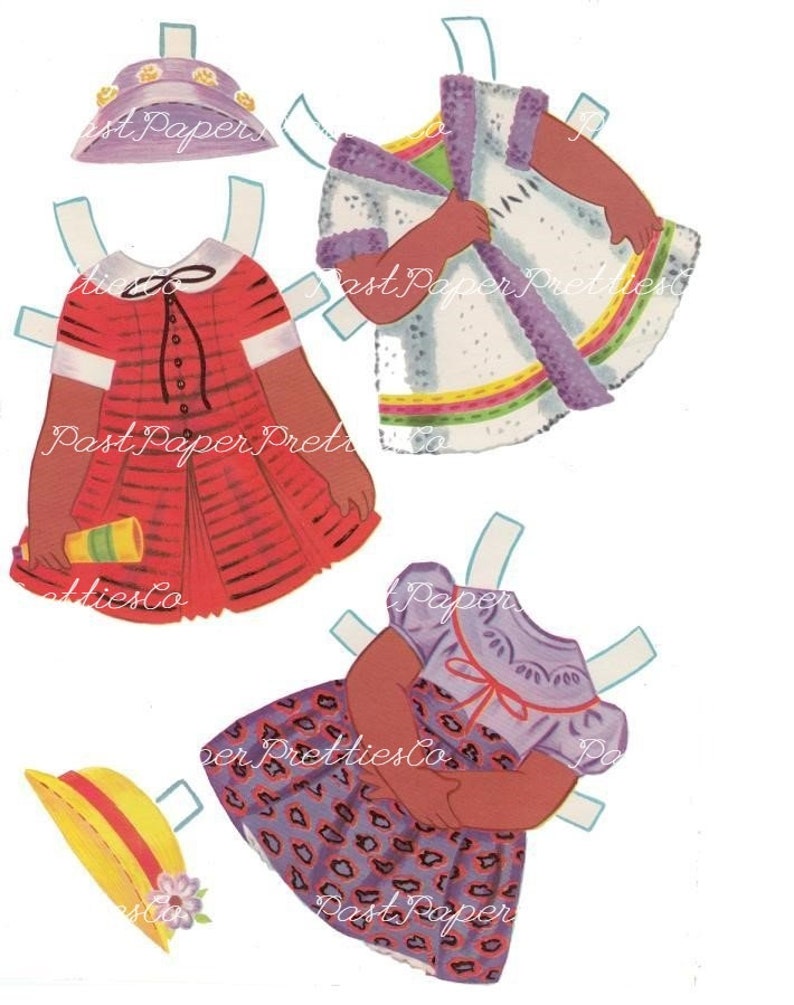 May include: A paper doll with different outfits. The doll has brown skin and is wearing a purple dress with a white collar and a red and white striped dress. The doll also has a purple hat with flowers and a yellow hat with a red band.