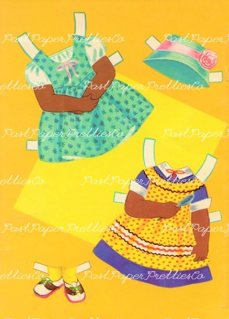 May include: Two paper dolls with black skin, one wearing a green dress with white polka dots and the other wearing a yellow dress with red and white trim and blue accents. Both dolls have white arms and legs.