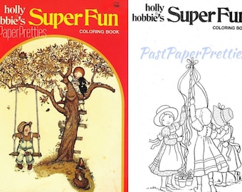 May include: A coloring book cover featuring a girl on a swing and a girl climbing a tree. The book is titled "Super Fun Coloring Book" and is by "holly hobbie's Past Paper Pretties".