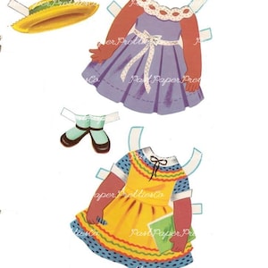 May include: A vintage paper doll set with a brown-skinned doll and two outfits. The first outfit is a purple dress with a white bow and white polka dots. The second outfit is a yellow dress with a blue and white polka dot pattern, a green book, and a red, yellow, and green trim.