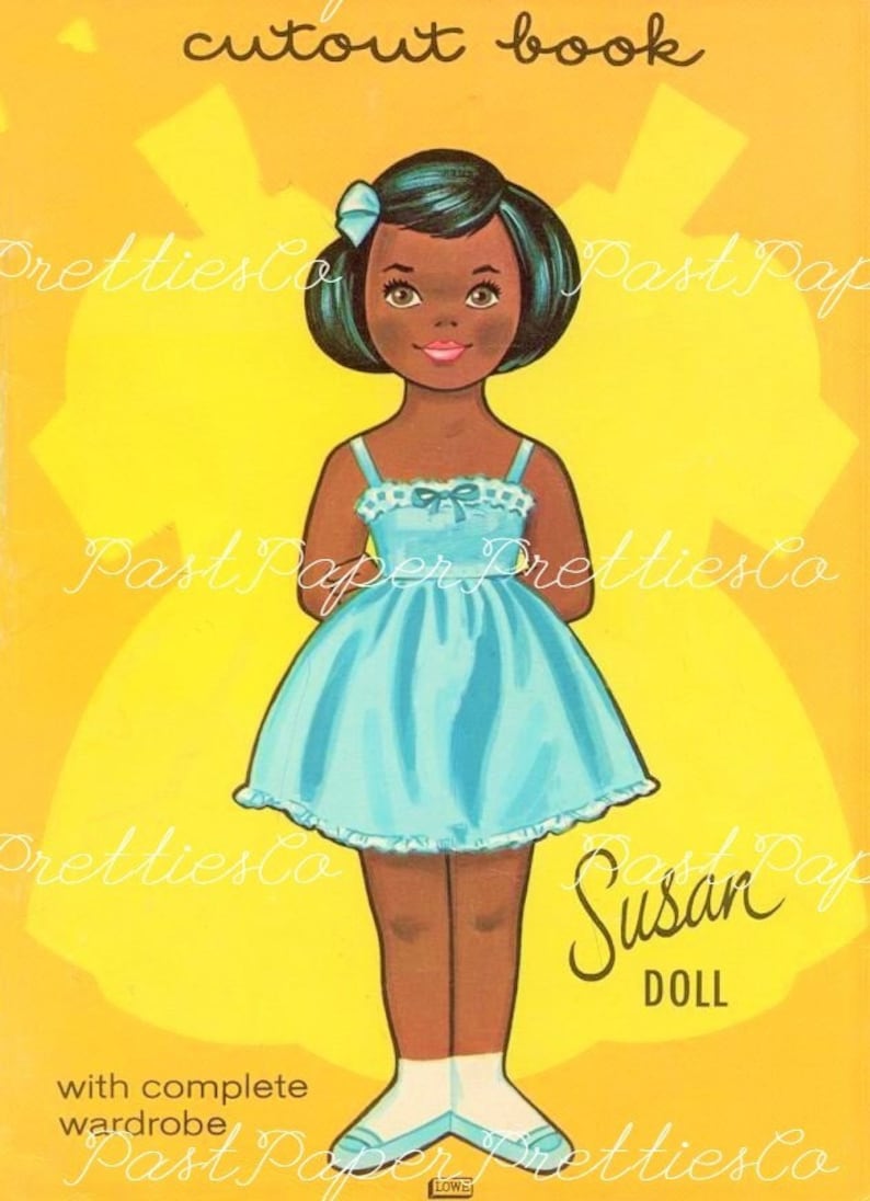 May include: A paper doll cutout book featuring a Black girl doll named "Susan Doll" wearing a blue dress with white trim. The doll has black hair, brown eyes, and a light pink mouth. The background is yellow with a star pattern.