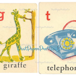 May include: Two flashcards with a letter and a picture. The first card has the letter 'g' in red and a green and yellow giraffe eating leaves from a tree. The second card has the letter 't' in red and a blue rotary phone with a red cord. The words 'giraffe' and 'telephone' are printed below the pictures.