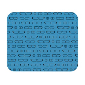 May include: A rectangular blue mousepad with a repeating pattern of black eyeglasses. The eyeglasses are in various styles, including rectangular and round frames. The mousepad has rounded corners and a white border.