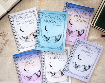 May include: A collection of spiral-bound journals with fantasy-themed covers. Each journal features a unique title such as "The Enchanted Library" and "Echoes of the Stars", along with illustrations of mountains and crescent moons. The covers have a watercolor effect.