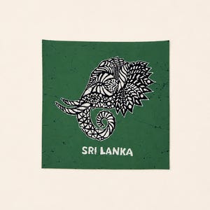May include: A square green textile featuring a black and white elephant head illustration with intricate geometric patterns. The elephant is depicted in profile with its trunk curled. The text SRI LANKA is printed in white below the elephant.