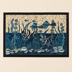 May include: A rectangular textile featuring an underwater scene with fish and aquatic plants. The artwork uses shades of blue and white against a beige background, framed by a black border. The fish have striped patterns.