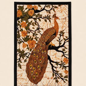 May include: A framed textile art piece featuring a peacock perched on a tree branch. The peacock has brown and gold feathers, with a long tail. The tree has orange flowers and green leaves. The background is off-white with brown veins.