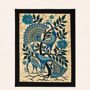 May include: A rectangular wall hanging featuring a batik-style print of two blue peacocks perched in a tree with dark blue leaves and flowers. The background has a cream-colored crackled texture, and the entire piece is framed by a solid black border.