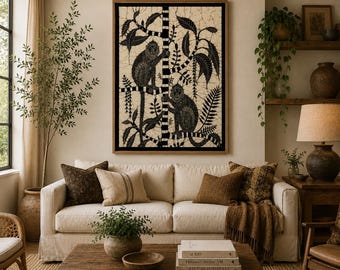 May include: A framed wall art piece featuring a black and white batik-style illustration of two monkeys climbing a tree. The artwork is displayed above a beige sofa with brown throw pillows, a wooden coffee table, and a potted plant.