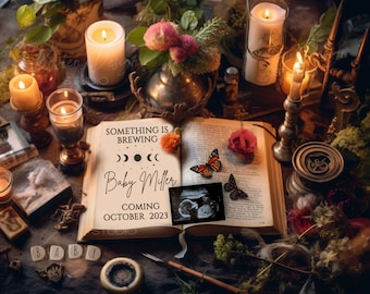 May include: A vintage book with a black and white ultrasound image, a butterfly, and the text "Something is brewing. Baby Miller. Coming October 2023." The book is surrounded by candles, flowers, and other decorative items.