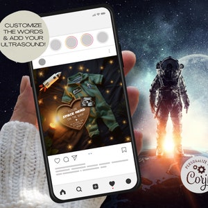 May include: A smartphone displaying a social media post with a photo of a baby onesie and a wooden heart with the text "Future Space Nerd On The Way" and a small ultrasound image. The post is set against a dark blue background with stars and a rocket ship. The phone is held in a hand wearing a white sweater. The background of the image is a dark blue sky with stars and a planet.