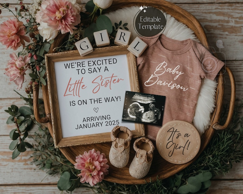 May include: A baby announcement with a framed sign that reads "We're excited to say a little sister is on the way! Arriving January 2025". There is a pink baby onesie with the text "Baby Davison", a wooden sign that says "It's a girl!" and a framed ultrasound image.