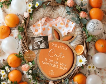 May include: Orange themed baby announcement featuring a wooden orange slice sign that reads "Our Little Cutie Is On The Way November 2024". The sign is surrounded by oranges, white balloons, and a baby onesie with orange print.