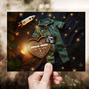 May include: A wooden heart-shaped sign with the text "Future Space Nerd On The Way! Blasting Off September 2024" and a small rocket ship and a baby onesie with a NASA patch.