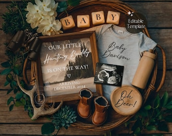 May include: A wooden sign with the text "Our Little Hunting Buddy is on the way!" and "Arriving December 2024". A framed ultrasound image, a baby onesie with the text "Baby Davison", wooden blocks spelling "BABY", a wooden bottle, a pair of brown baby booties, and a wooden coaster with the text "Oh Deer!" are arranged on a woven basket.