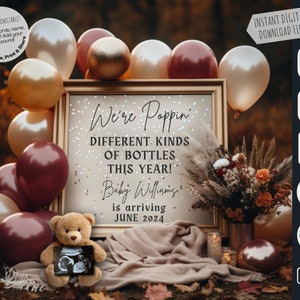 May include: A gold framed sign with the text "We're Poppin' Different Kinds of Bottles This Year! Baby Williams is arriving June 2024". The sign is surrounded by brown, gold, and white balloons. A teddy bear holding an ultrasound image is in the foreground.
