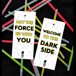 May include: Two white cards with black and yellow text. The first card says "May the Force be with you." The second card says "Welcome to the Dark Side."