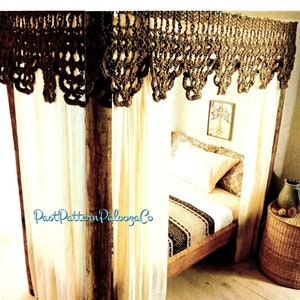 May include: A crocheted canopy for a bed, made with brown yarn. The canopy is draped over a wooden bed frame with white curtains. The bed is made with a white sheet and a patterned blanket.