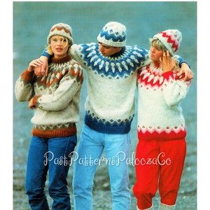 May include: Three people wearing knitted sweaters and hats with traditional Norwegian patterns. The sweaters are white with blue, red, and brown accents. The hats are white with blue and red accents. The people are standing on a rocky beach.