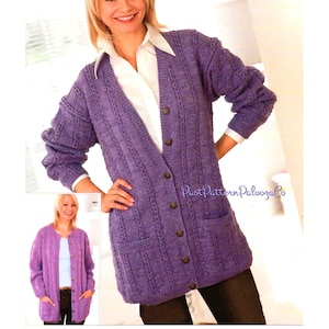 May include: A purple knitted cardigan with a cable knit pattern, long sleeves, and a button-up front. The cardigan has two pockets on the front and is shown being worn by a model.