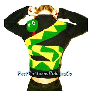 Könnte beinhalten: Schwarzer Strickpullover mit einem grünen und gelben Schlangenmuster. Die Schlange hat einen grünen Kopf mit weißen Augen und einer roten Zunge. Der Pullover hat lange Ärmel und einen hohen Ausschnitt. Der Text "PastPatternsPaloozaCo" ist sichtbar.