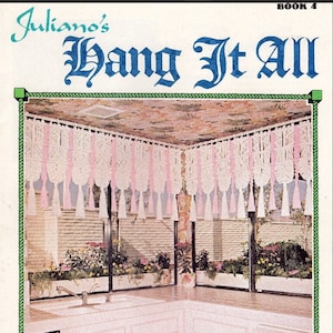 May include: A kitchen with pink cabinets and a white countertop. The kitchen has a window with a macrame curtain with pink tassels. The text "Juliano's Hang It All Book 4 Sweet and Sassy" is printed on the page.